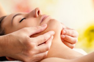 44647493 - macro close up of hands massaging female chin. therapist applying pressure with fingers on face.